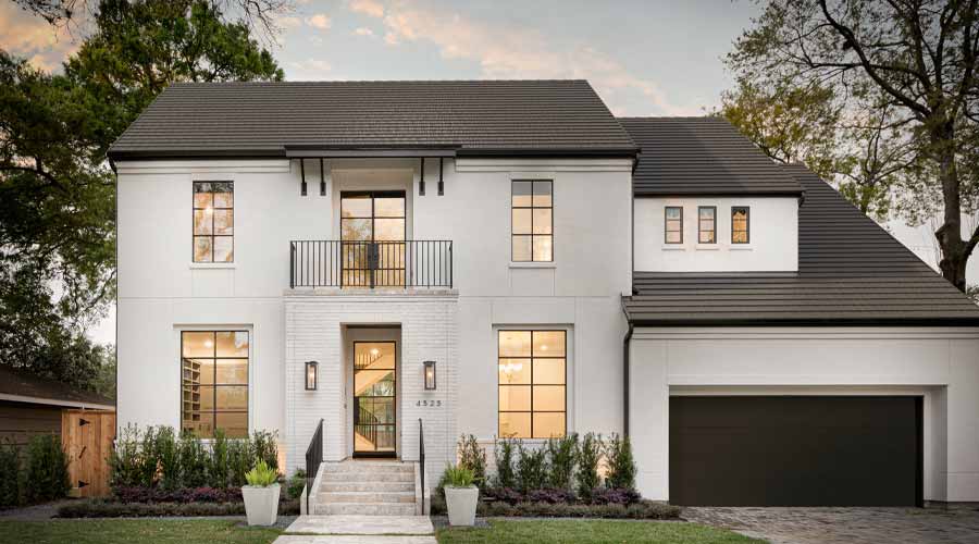 worker on roof installing shingle at sunrise